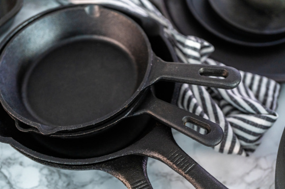 Some cast iron pans placing on a table.