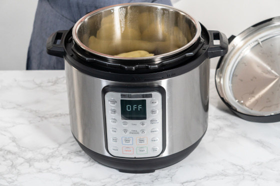 An instant pot with some potatoes in it.