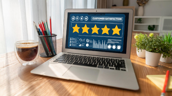 A laptop showing customer satisfaction of five stars