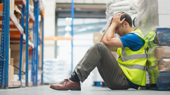 Tired worker sitting on the couch with a headache