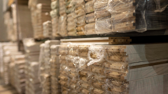 Raw material wood pallet stocking on warehouse shelves